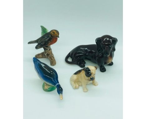 A selection of china animals to include a Royal Doulton Bull Dog, Branksome Duck and Dachshund and Robin by Goebel.