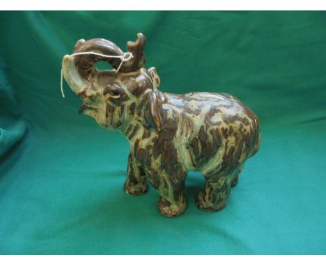 Royal Copenhagen glazed ceramic elephant ornament in traditional greens and browns by Knud Kyhn marked and signed KK to foot 