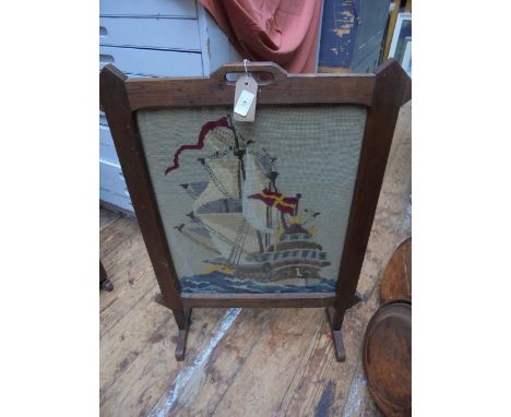 Oak framed fire screen inset needlework panel of a sailing ship