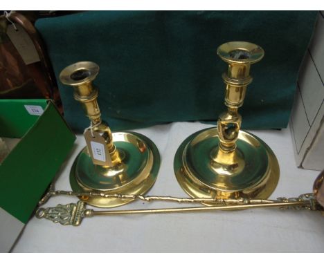 Pair of 19th century brass candlesticks each on circular base together with brass poker and toasting fork