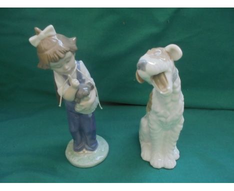 2 Nao figures, one of a young girl holding her doll and another of a yawning dog
