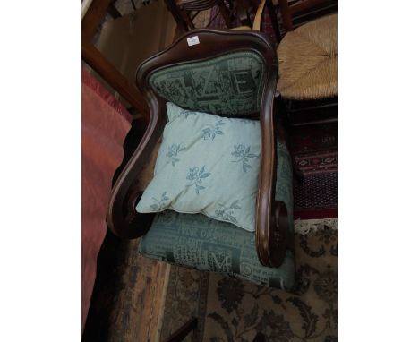 Victorian mahogany framed armchair on reeded feet on brass castors, the padded back and seat upholstered in modern patterned 