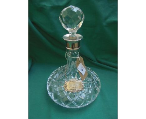 Silver mounted (Birmingham 1983) cut glass ships decanter with golf ball stopper and silver brandy label (Birmingham 1979)