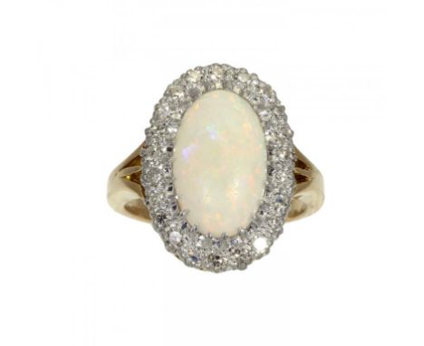 AN OPAL AND DIAMOND CLUSTER RING  in gold marked 18ct PLAT, 6.7g, size L ++The opal   lacking   polish from wear but not crac