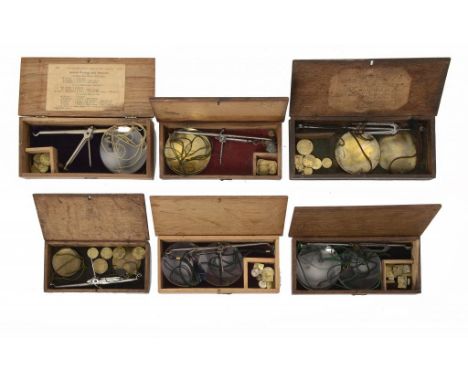 FOUR ENGLISH COIN SCALES IN OAK BOXES, EARLY 19TH C with steel beam and brass pans, one with engraved trade label to the unde