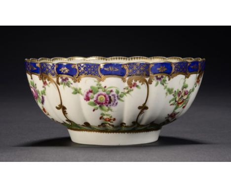 A WORCESTER BLUE BORDERED SLOP BASIN, C1780-85  enamelled with swags and a shagreen background, 16cm diam, script W ++In fine