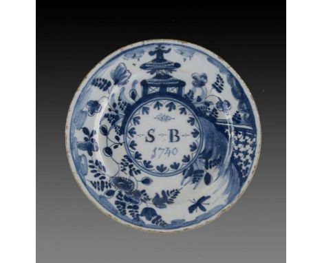 AN ENGLISH DELFTWARE PLATE, DATED 1740  painted to the centre with the initials SB 1740 in a Kangxi style border of pagoda an