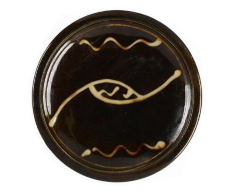 RAY FINCH (1914-2012) A PRE WAR SLIPWARE DISH, C1939 21cm diam, impressed potter's and Winchcombe Pottery seals, Bankfield Mu