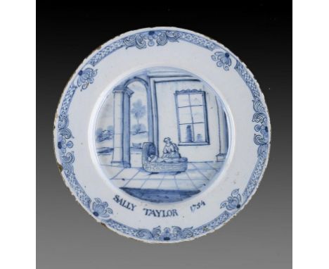 AN ENGLISH DELFTWARE PLATE, DATED 1764  attractively painted with the seated figure of a young woman rocking her baby in a cr