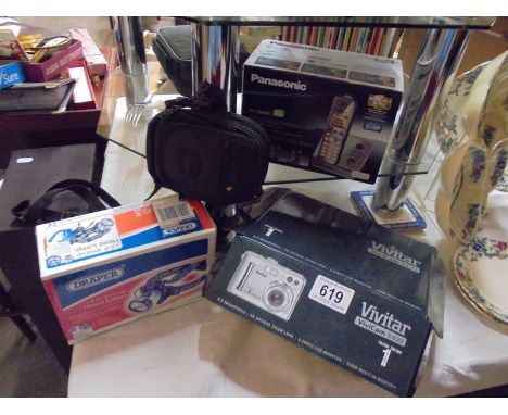 A Panasonic telephone, a vivitar camera, another camera and an LED head lamp.
