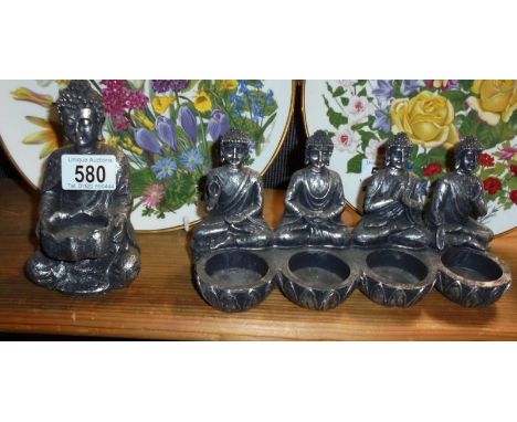 Two Buddha tea light holders.