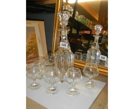 A decanter and six glasses.