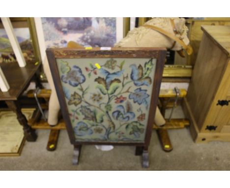 A needlework firescreen