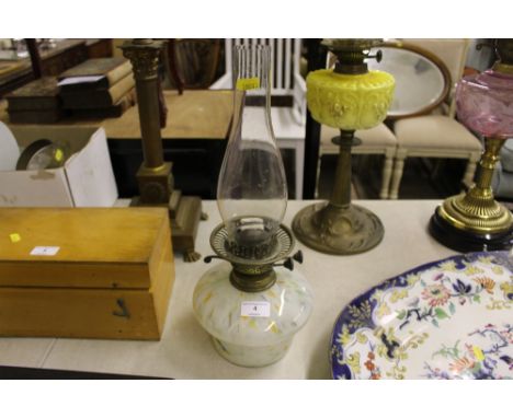 A oil lamp with mottled glass font 