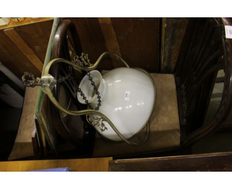 A brass hanging lamp with milk glass shade 