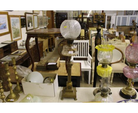 A brass and clear glass oil lamp