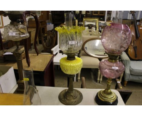 An Art Nouveau brass and yellow glass oil lamp 