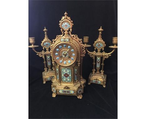 A French gilt brass clock garniture, case marked Brunfaut, with enamelled features.
