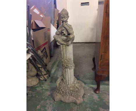 Tall garden ornament of an elf playing pipes.