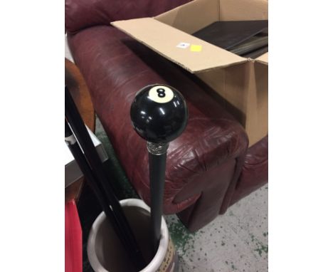 A black number 8 pool ball walking stick