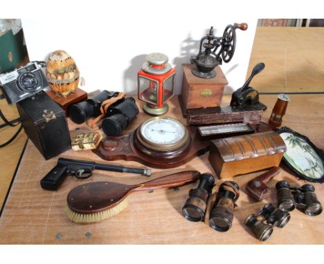 An assorted group of collectibles to include a hand-cranked coffee grinder, an aneroid barometer/thermometer, a modern storm 