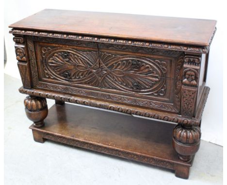 A 1930s Jacobethan cabinet of two-over-one drawers flanked by pilaster columns and supported on bulbous turned legs to shelf 