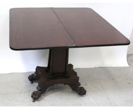 A William IV mahogany fold-over card table on square column support to platform base on paw feet to brass castors, width 89cm