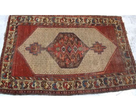 An Eastern tribal hand-knotted carpet, the central medallion decorated with geometric patterns on a diaper pattern reserve to