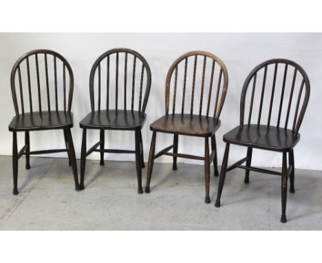 A set of four dark stained Ercol stick-back chairs, with Ercol paper labels (4).