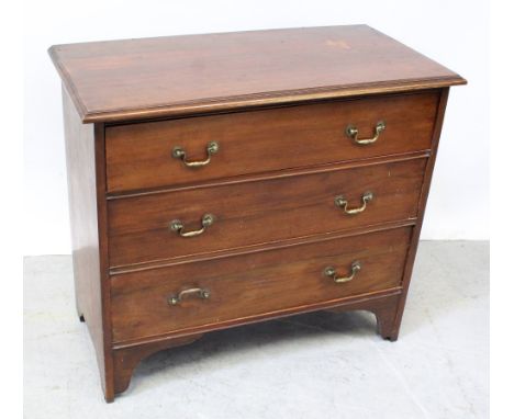 An Edwardian walnut chest of three drawers on bracket feet, formerly a dressing chest, height 82cm.