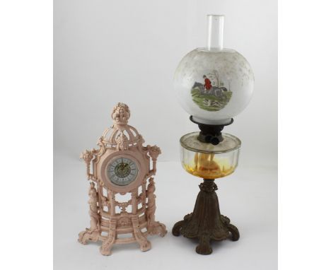 A vintage wrought iron and brass paraffin lamp with glass reservoir and printed globe shade with hunt scene, height 61cm and 