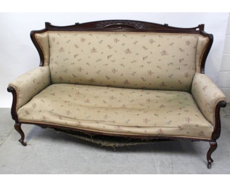 An Edwardian mahogany-framed salon sofa in the French style with carved back rail to outswept arms, on cabriole supports and 