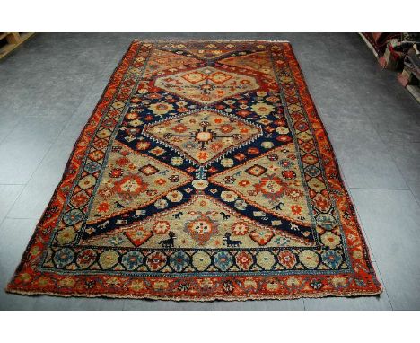 A vintage wool woven Eastern-inspired rug, three octagonal medallions with geometric design within a geometric blue, brown an