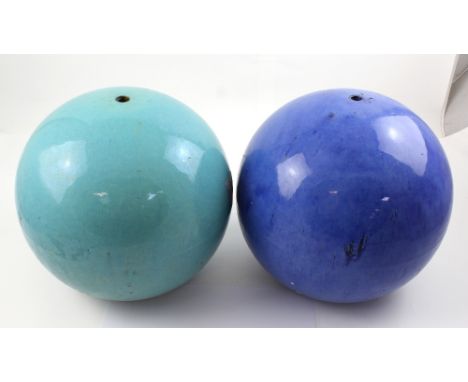 Two coloured ceramic garden globes, on in blue drip glaze the other in turquoise, height of each approx 28cm (2).