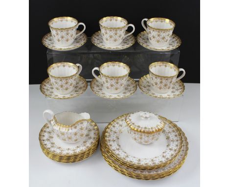 A Spode 'Fleur-de-Lys' gold pattern part dinner and tea service comprising six cups, six saucers, six side plates, milk jug, 