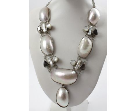 A vintage white metal chain and blister pearl necklace.