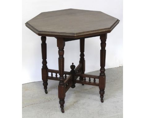 A Victorian mahogany octagonal occasional table on turned fluted and reeded legs united by bobbin-turned double X-stretcher t