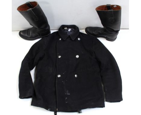 A fireman's six-button black tunic and a pair of black leather firemen's boots.