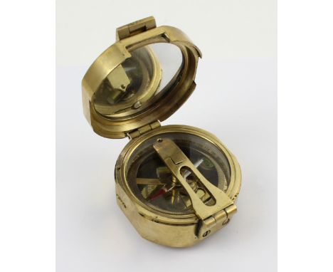 A brass maritime compass with internal spirit levels and signalling mirror, marked 'Stanley London', width 5.5cm.