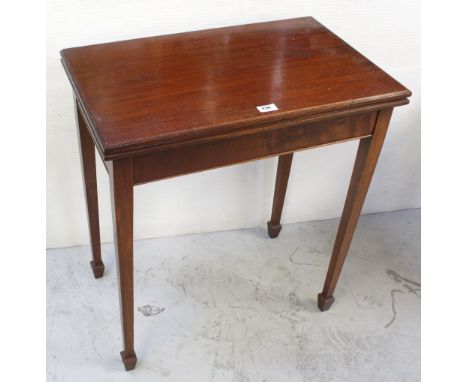 An Edward VII Waring &amp; Gillow mahogany fold-over card table in the Arts and Crafts style, on square tapering legs to spad