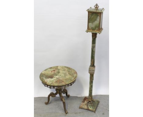 An Italian-style onyx and gilt circular side table with decorative scrolling side to wrythen column and tripartite supports, 