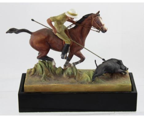 A 1936 Doris Lindner ceramic figure entitled 'Hog Hunting' with mounted hunstman in pith helmet trying to spear a wild boar, 