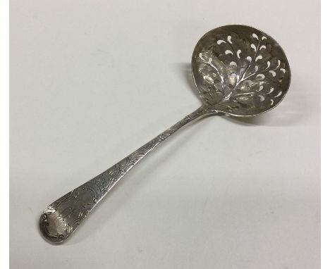 A pierced silver sifter spoon cast with flowers and leaves. London 1764. Approx. 38 grams. Est. £35 - 345.