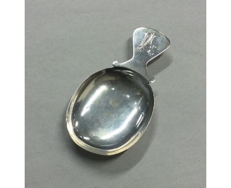 A Continental silver caddy spoon with shaped rim. Approx. 15 grams. Est. £20 - £30.