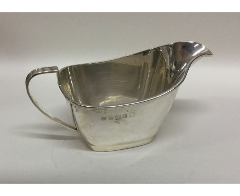 An engine turned silver sauce boat with reeded border. Birmingham. Approx. 89 grams. Est. £25 - £35.