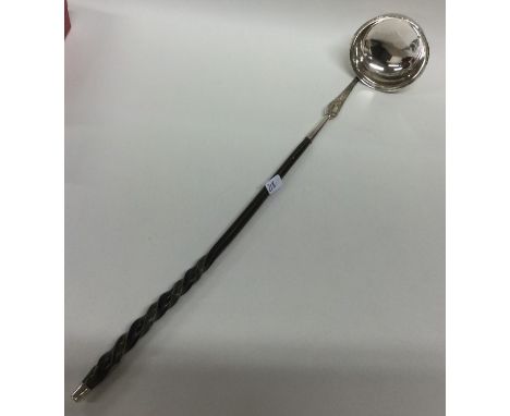 An 18th Century silver bright cut toddy ladle with whalebone handle. Approx. 13 grams. Est. £35 - £45.