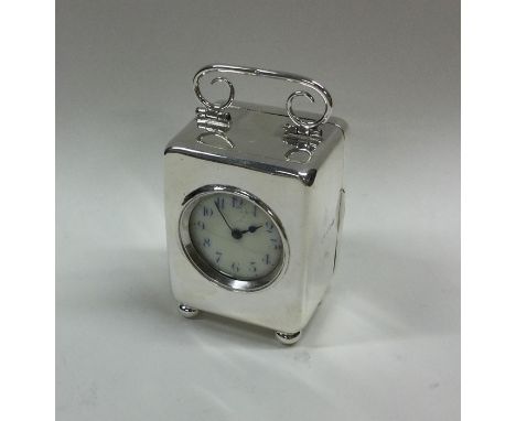A good silver travelling carriage clock on four ball feet with white enamelled dial. Birmingham 1909. By Henry Davis. Approx.