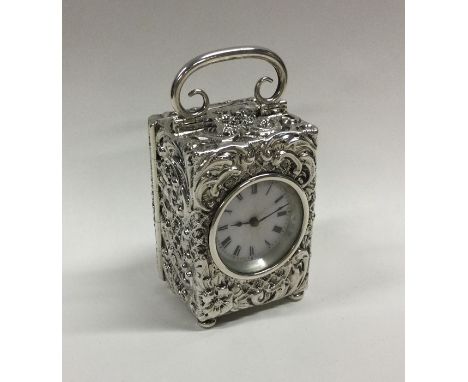A good silver embossed carriage clock with scroll decoration and white enamelled dial. London. By CD. Approx. 253 grams. Est.