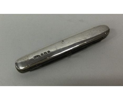 An Edwardian silver combination travelling knife. Birmingham. By L&amp;S. Approx. 15 grams. Est. £25 - £35.