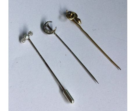 A good diamond and pearl three stone stick pin together with a snake pin etc. Approx. 5 grams. Est. £250 - £350.